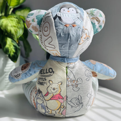 memory bear for baby boy with cartoon characters on a white surface